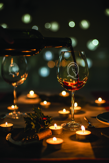 Glasses of red wine with candles